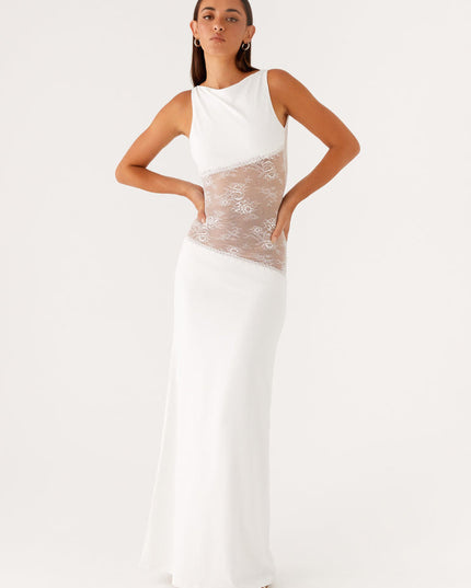 White sleeveless maxi dress with a sleek design, featuring intricate lace cut-outs on the sides of the bodice, offering a modern look.