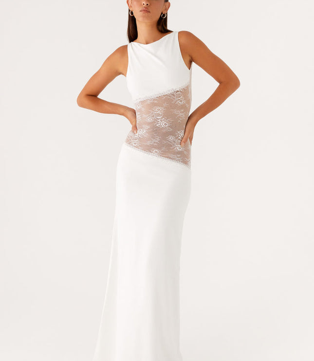 White sleeveless maxi dress with a sleek design, featuring intricate lace cut-outs on the sides of the bodice, offering a modern look.