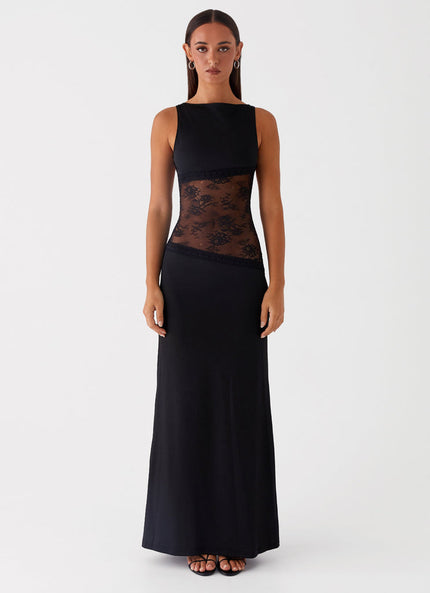 Sleeveless black maxi dress with intricate lace cut-out details on the torso, featuring a sleek, form-fitting silhouette.
