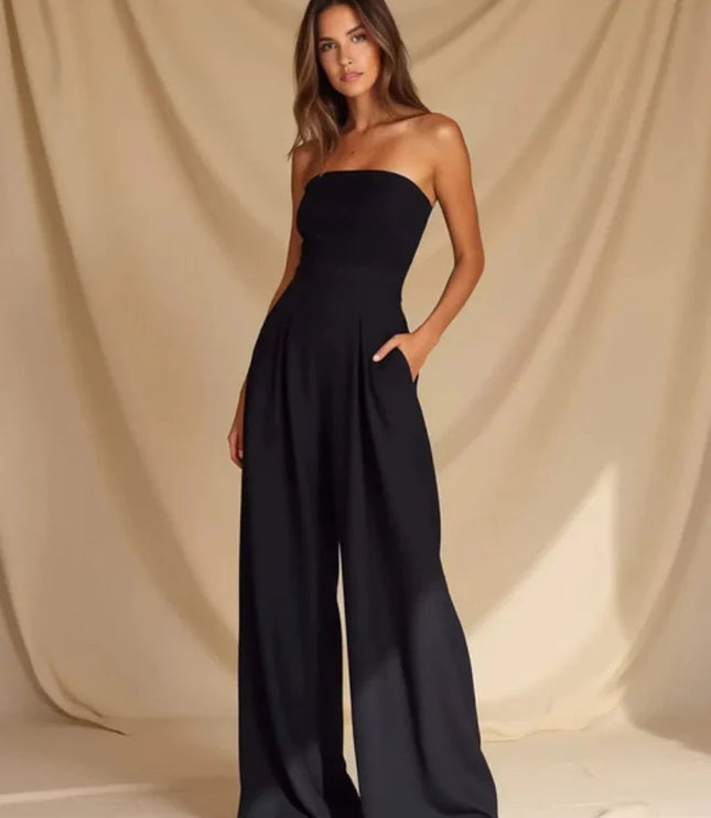 Back view of a navy strapless wide leg jumpsuit with smooth fitted top and flowing pants