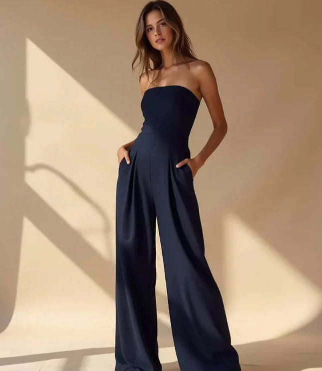 Navy strapless wide leg jumpsuit with fitted waist and side pockets on a model