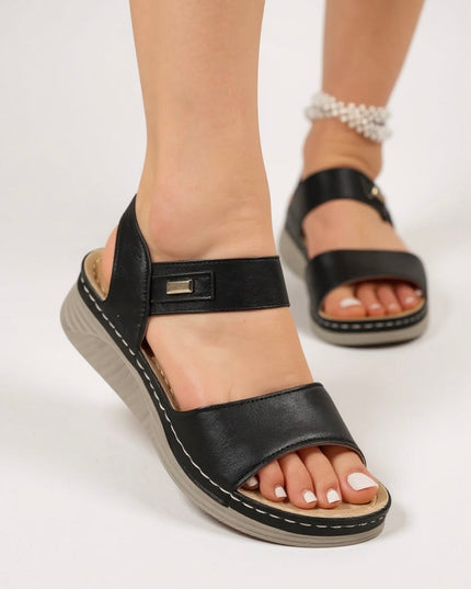Black strappy leather platform sandals with contoured footbed and metal hardware