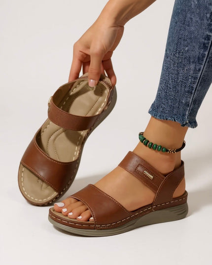 Brown leather strappy platform sandals with adjustable ankle strap and cushioned sole