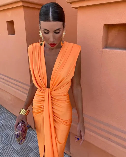 Close-up of orange deep V neck maxi dress with gathered waist and sleeveless cut, summer dress