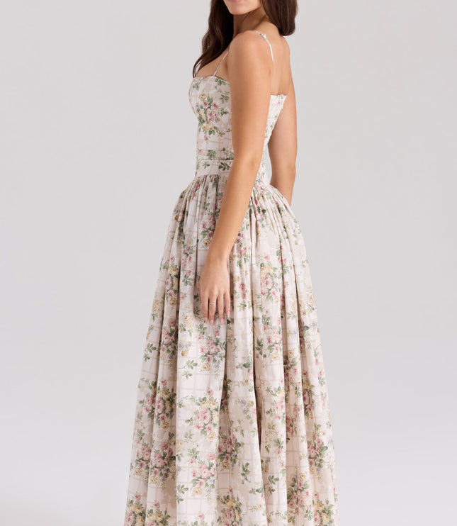 Side view of the white and pink floral corset midi dress, showcasing the full skirt and tailored fit.