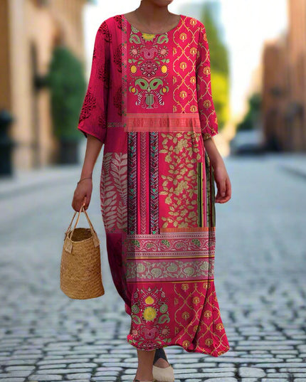 Women summer printed maxi dress in pink shown on a model with long sleeves and mixed print design