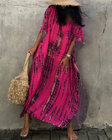Bright pink tie dye maxi dress with V-neck, sheer loose sleeves, and relaxed boho summer dress shape