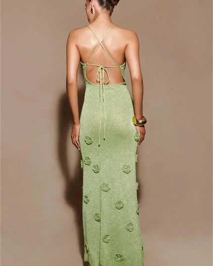 Back view of a light green maxi dress with criss-cross straps, tie-back detail, and 3D floral appliques.
