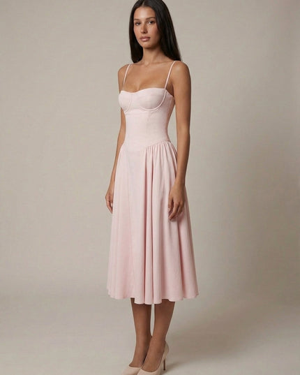 Light pink corset midi dress with thin straps and flowing pleated skirt