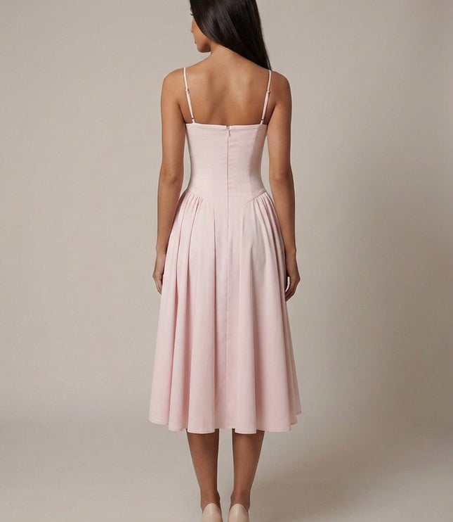 Back view of blush corset midi dress showing zip closure