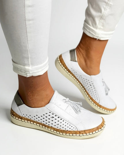 White suede tassel slip-on loafer with perforated sides and cork trim