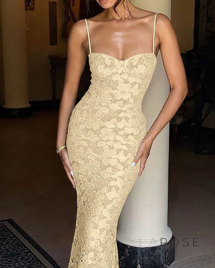 Close-up of the bodice and skirt of a women's beige lace spaghetti strap midi dress, highlighting the detailed floral lace texture.