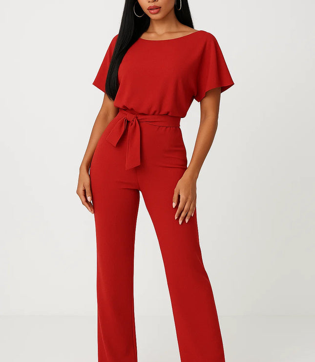 Red wide leg jumpsuit with short sleeves, tie waist belt, and flowing leg shape