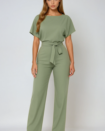Sage green wide leg jumpsuit with short sleeves, boat neckline, and tied waist belt