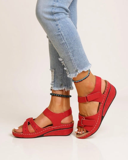 Red adjustable wedge platform sandals with buckle straps and contrast stitching