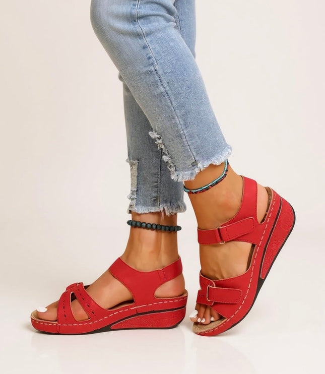Red adjustable wedge platform sandals with buckle straps and contrast stitching