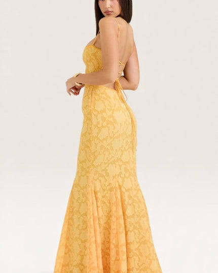 Back view of yellow jacquard maxi dress showing backless tie design