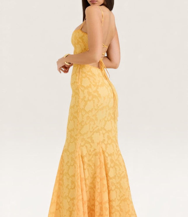 Back view of yellow jacquard maxi dress showing backless tie design