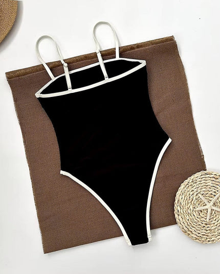 Black one piece bathing suit flat lay with woven beach accessories