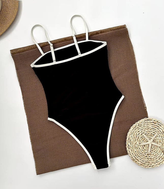 Black one piece bathing suit flat lay with woven beach accessories