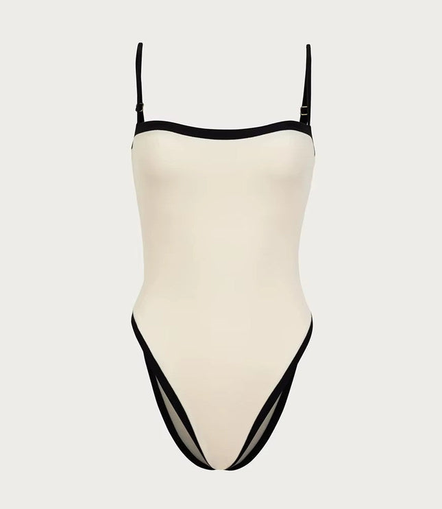 Cream bandeau one piece swimsuit with black trim and high leg cut
