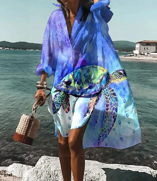 Blue beach mini shirt dress with abstract ocean print, long sleeves, and breezy button front