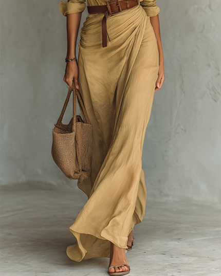 Beige maxi dress detail showing ruched skirt and brown leather belt