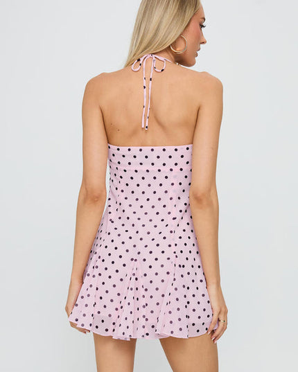 Back view of the pale pink polka dot halter mini dress with black dots, showing the tie-back.