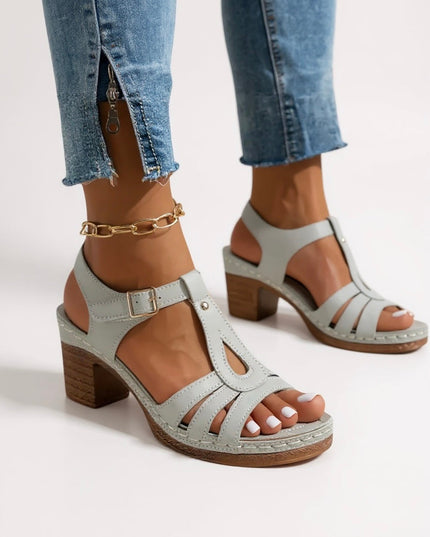 Light gray strappy sandals with block heel, platform sole, and ankle strap detail