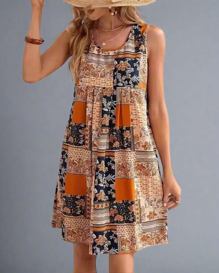 Front view of sleeveless patchwork mini dress in orange and navy floral print