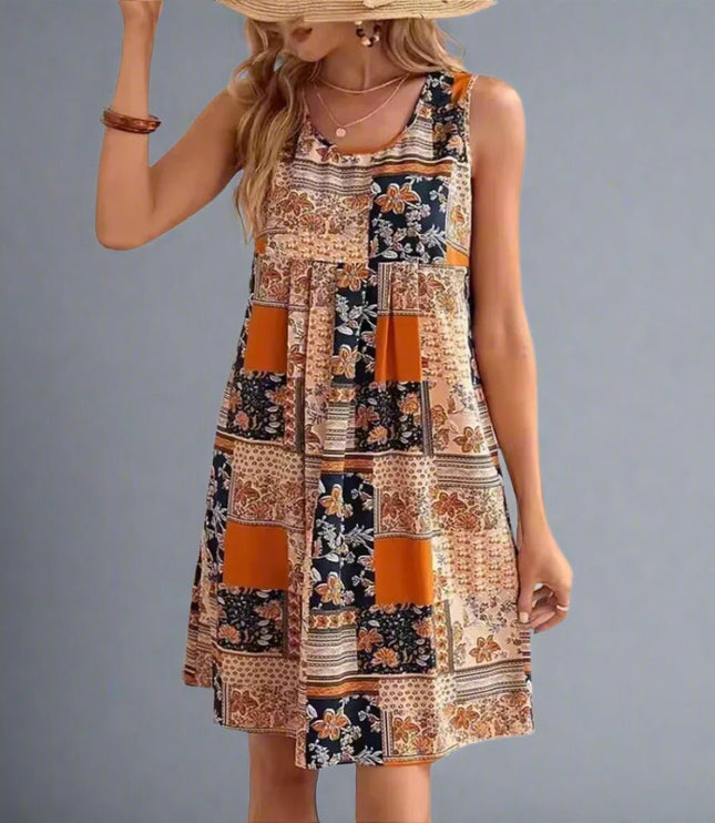 Front view of sleeveless patchwork mini dress in orange and navy floral print