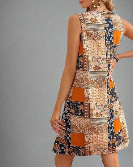 Back view of sleeveless summer patchwork mini dress with orange floral panels
