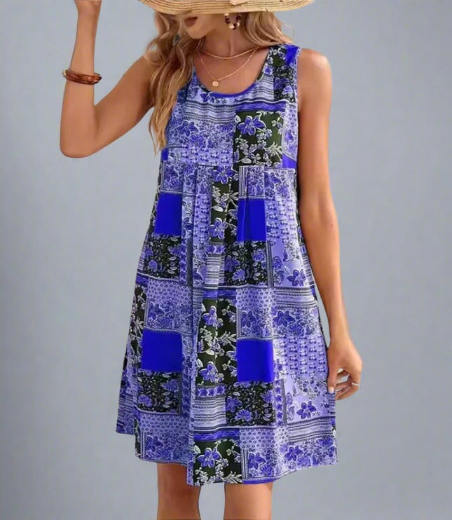 Sleeveless patchwork mini dress in blue and black floral print with round neckline