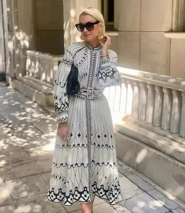 Full length A line midi dress with black and white print, long sleeves, and flowing skirt