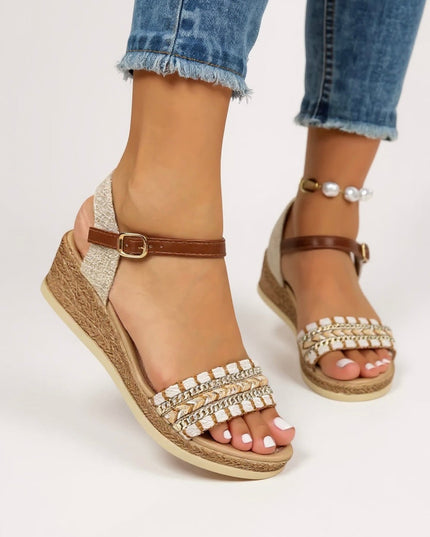 Side profile of women's braided wedge sandals with chain detail and buckle ankle strap