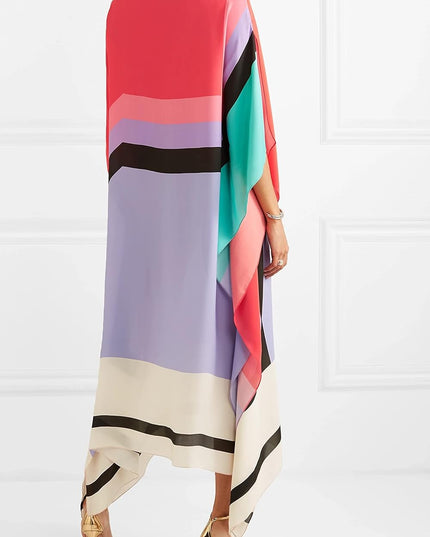 Back view of color block maxi dress showing draped asymmetrical hem and vibrant striped pattern
