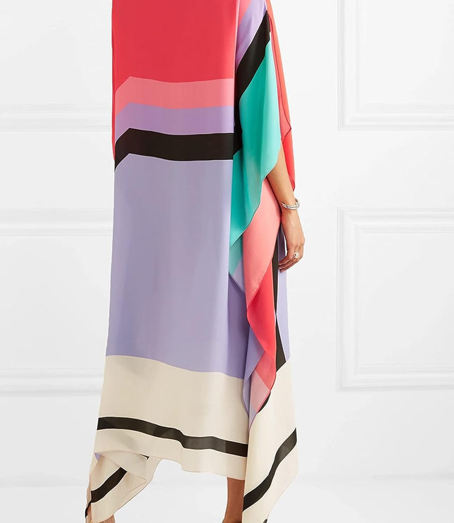 Back view of color block maxi dress showing draped asymmetrical hem and vibrant striped pattern