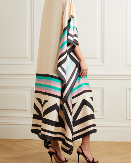 Rear detail of cream maxi dress with geometric striped hem and black abstract pattern
