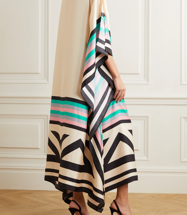 Rear detail of cream maxi dress with geometric striped hem and black abstract pattern