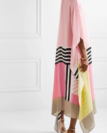 Side view of pink maxi dress with yellow, beige, and black striped color block design