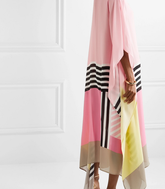 Side view of pink maxi dress with yellow, beige, and black striped color block design