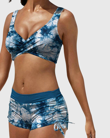 Blue tie-dye two-piece bikini with wrap-front top and ruched side-tie shorts