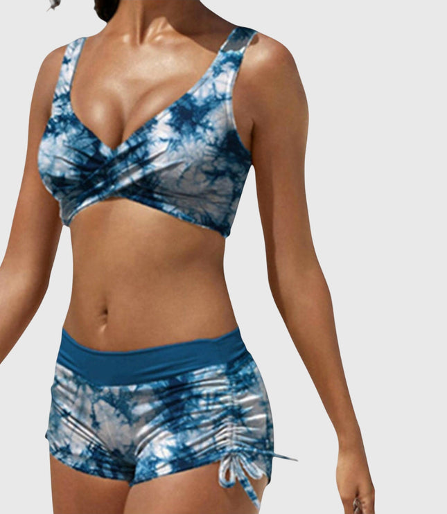 Blue tie-dye two-piece bikini with wrap-front top and ruched side-tie shorts