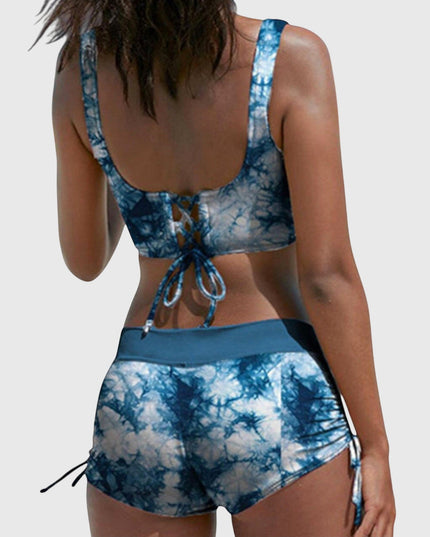 Back view of blue tie-dye bikini with lace-up back closure and side-tie shorts