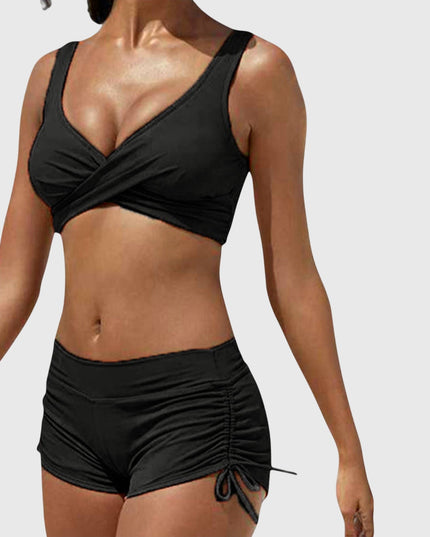 Black two-piece bikini with wrap-front top and ruched side-tie shorts
