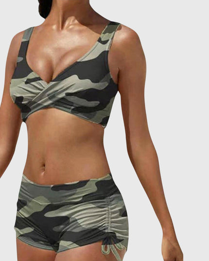 Camo two-piece bikini swimsuit with olive and black pattern, wrap-front top and ruched shorts