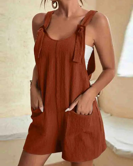 Rust red linen romper with adjustable tie shoulder straps and pockets