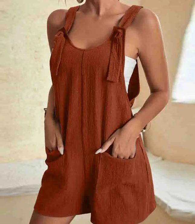 Rust red linen romper with adjustable tie shoulder straps and pockets