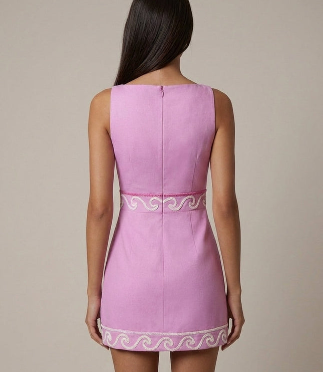 Back view of pink dress showing center zip closure and embroidered waist band