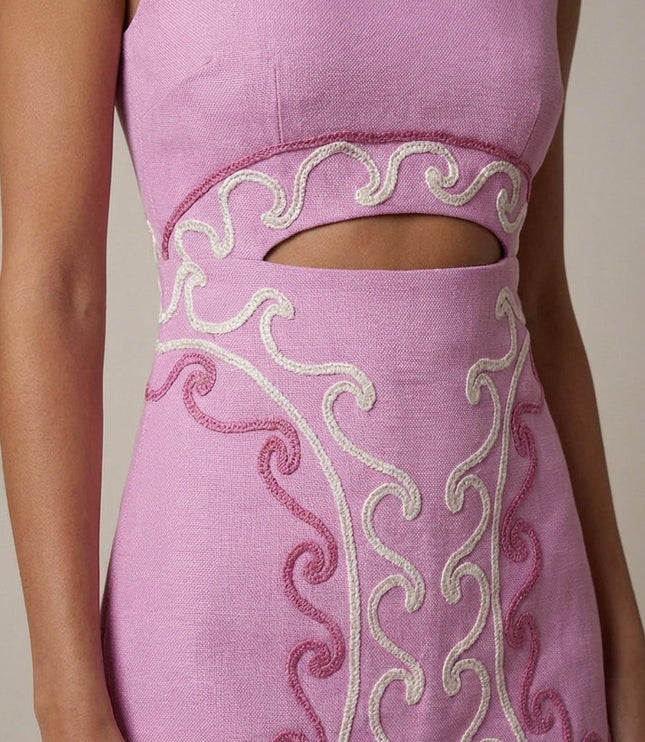 Close-up of cream and pink swirl embroidery detail on cocktail dress waist